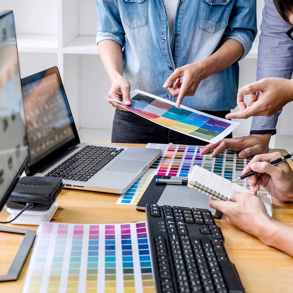 Team of brand creatives and designers working on creating a color palette for a brand.